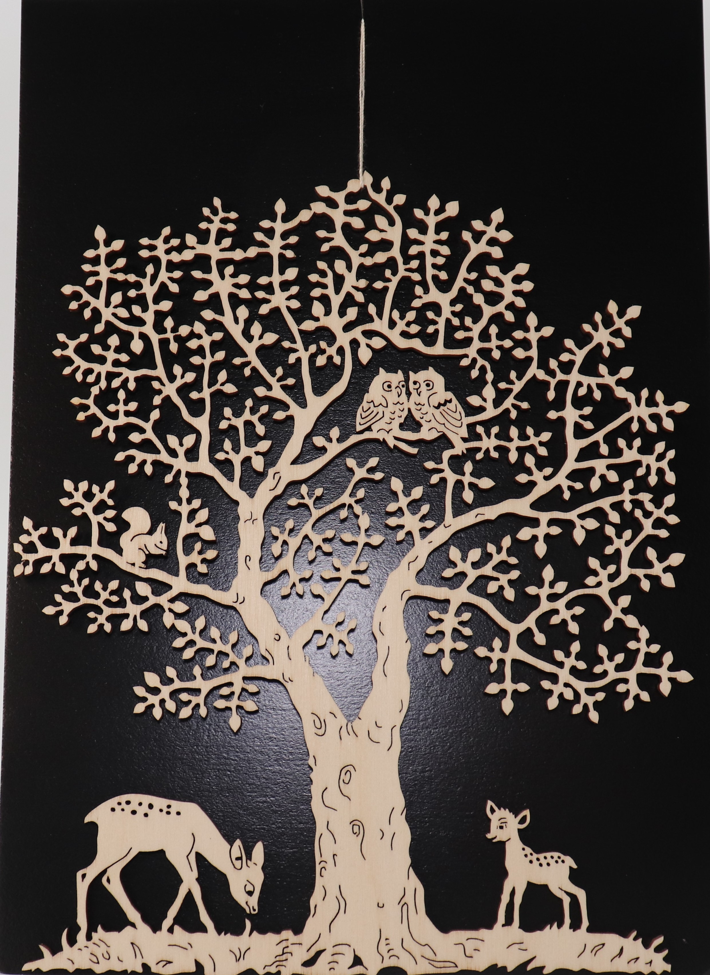 Fensterbild aus Holz mit Zwei Rehen unter einem Baum als Motiv.